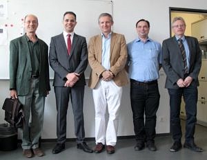 Prof. Stechele (TUM), É. Sousa, Prof. Teich, Prof. Wanka, Prof. Weigel (FAU) (from the left) standing next to each other in staff room of HSCD Chair smiling