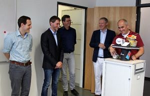 from the left: reviewers Prof. Hack (Saarland University), Prof. Stamminger (FAU), Prof. Teich and O. Reiche (second left) and Dr. Hannig (right) presenting the doctoral hat on an rolling table to the others (laughing)