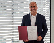 Picture of Frank Hannig with his appointment certificate