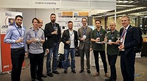 from right: J. Teich with team and M. Glaß (4th from left), University Ulm; all standing in front of the SFB/ESI booth