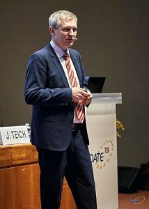 J. Teich standing on podium holding his welcome speech for DATE 2019