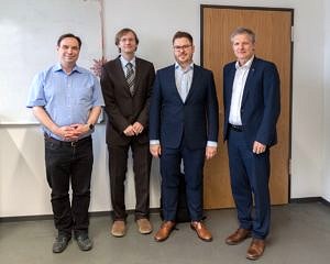 from the left: Prof. Wanka, Prof. Köstler, Chr. Schmitt, Prof. Teich standing and smiling 