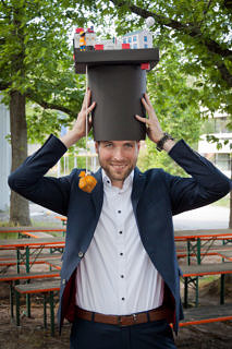 man with Doctoral cap in front of trees