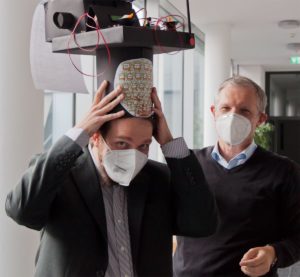 2 men with 1 doctoral hat