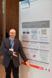 men in front of research poster