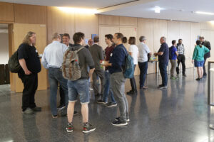 a group of people talk at the coffee break