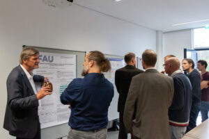 a group of people on the poster session