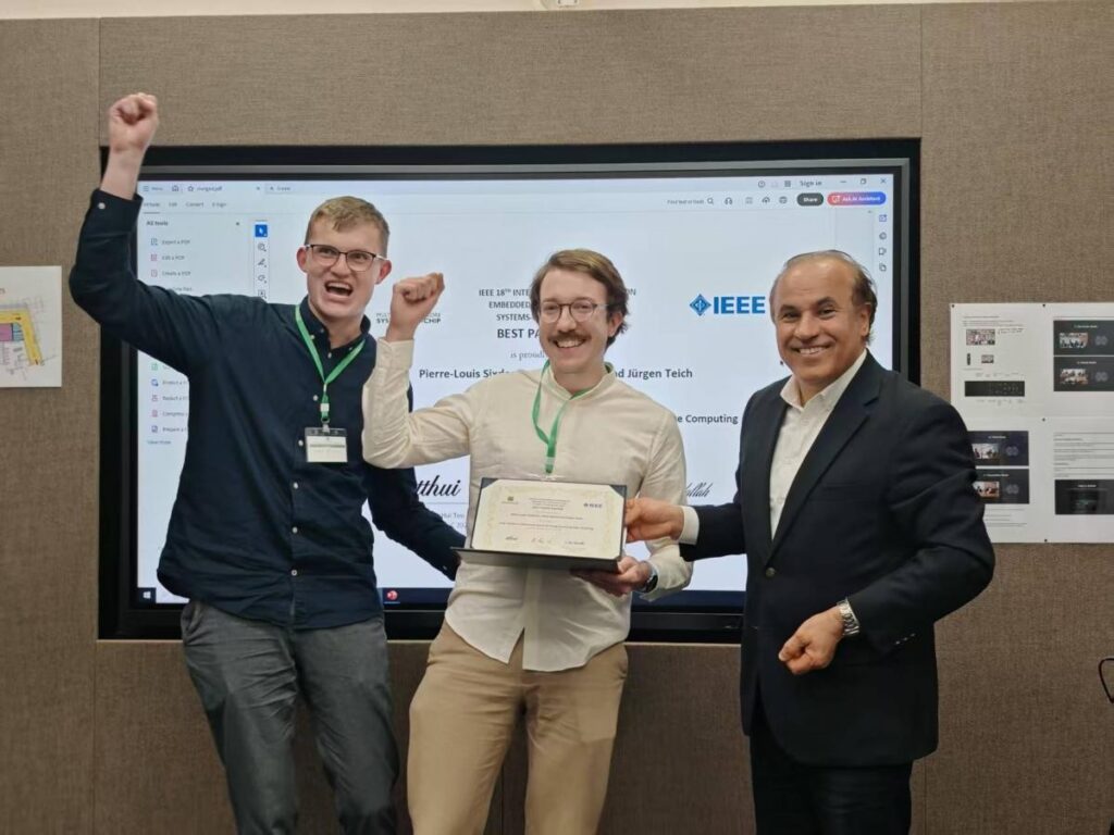 Three persons in front of a screen