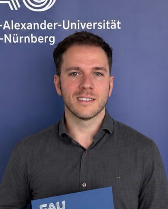 A man in front of a blue wall